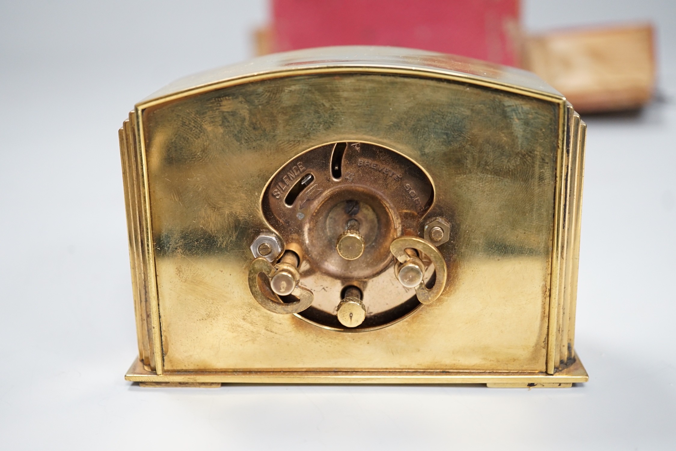 A cased Art Deco brass travelling timepiece